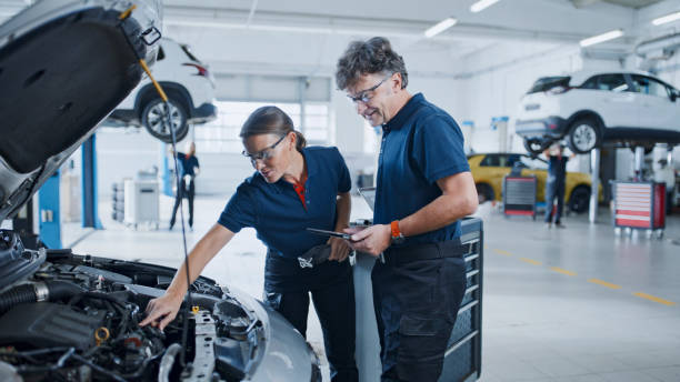 Manager And Mechanic Conducting A Thorough Inspection Of A Car Engine In The Auto Repair Shop