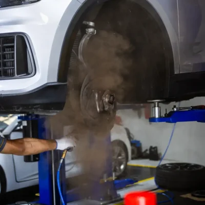 Car brake disc and red caliper for brake repair in Dubai
