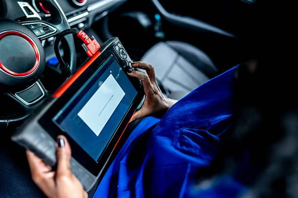 Close-up of a mechanic woman using digital tablet on a repair shop